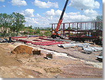 Steelwork in kit form for the left-hand block, to be erected within the next two weeks. Foundations now complete.